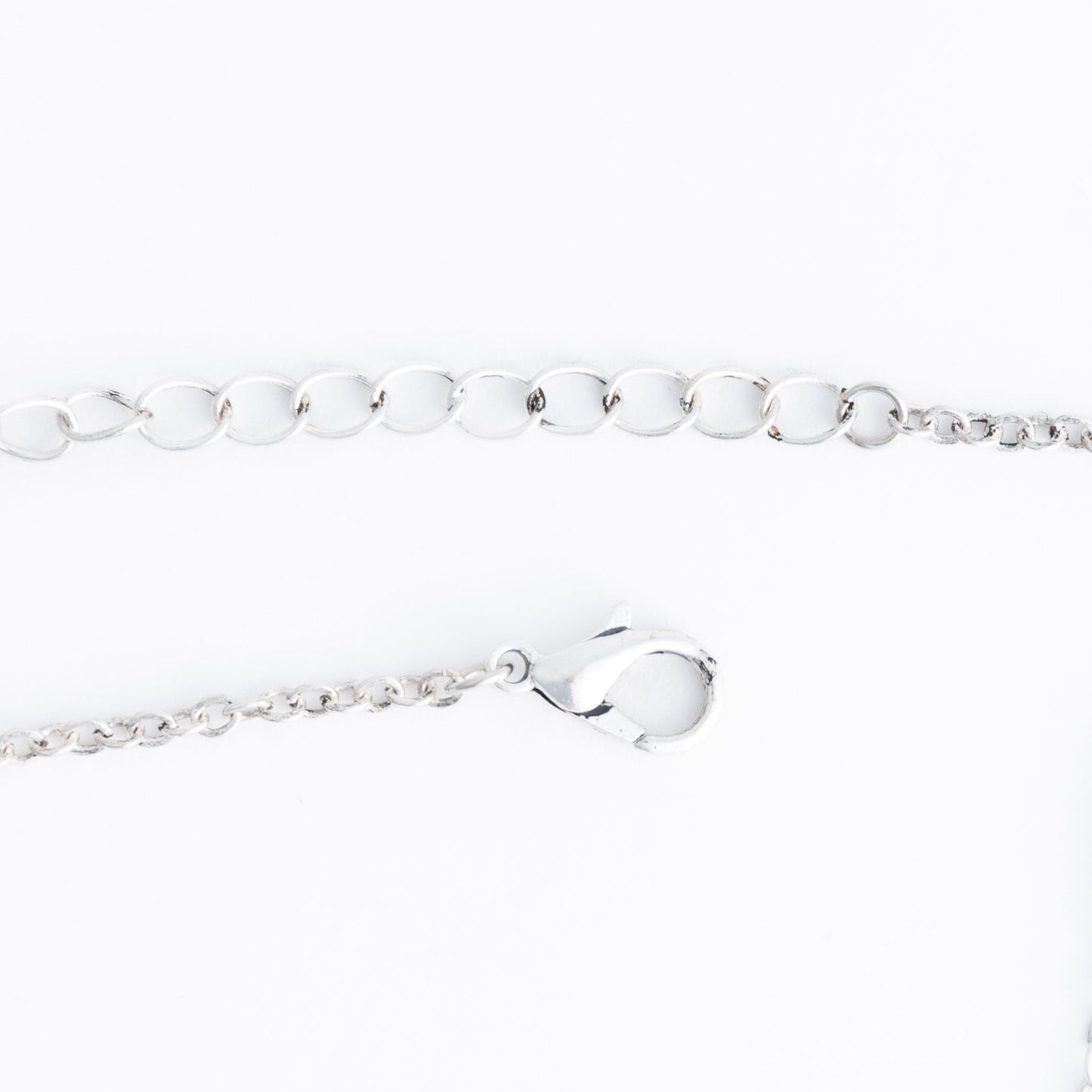 A silver lobster clasp necklace closure