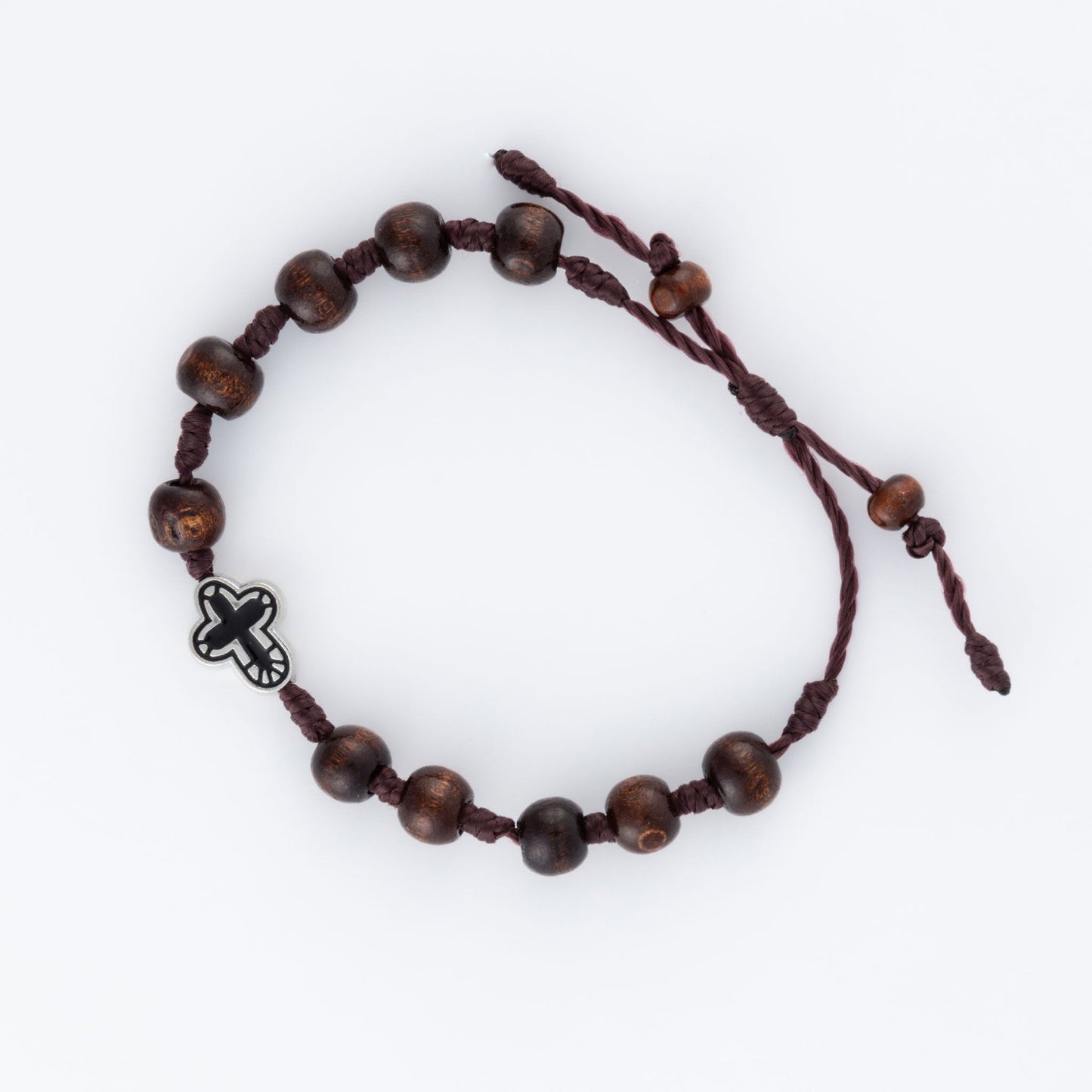 A beaded bracelet with dark wooden beads and a silver cross charm