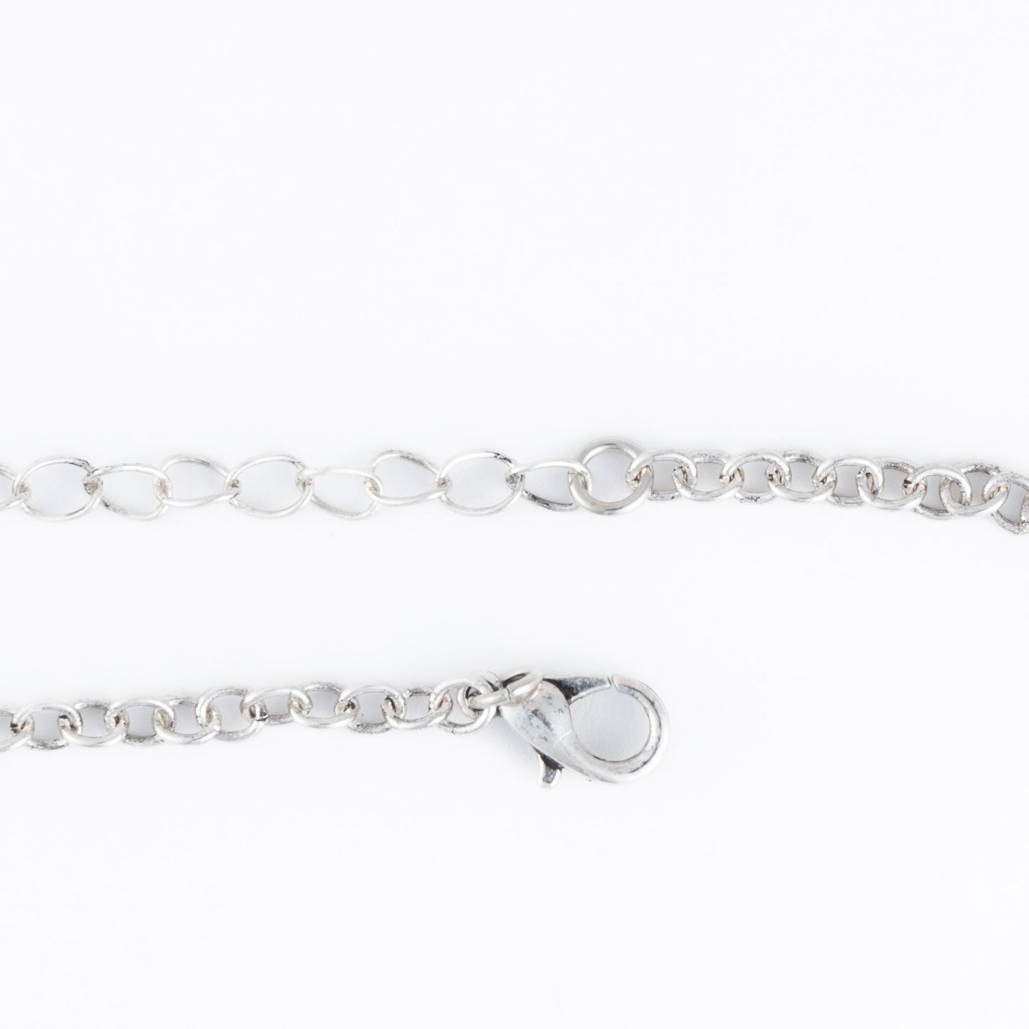 A silver necklace chain closure