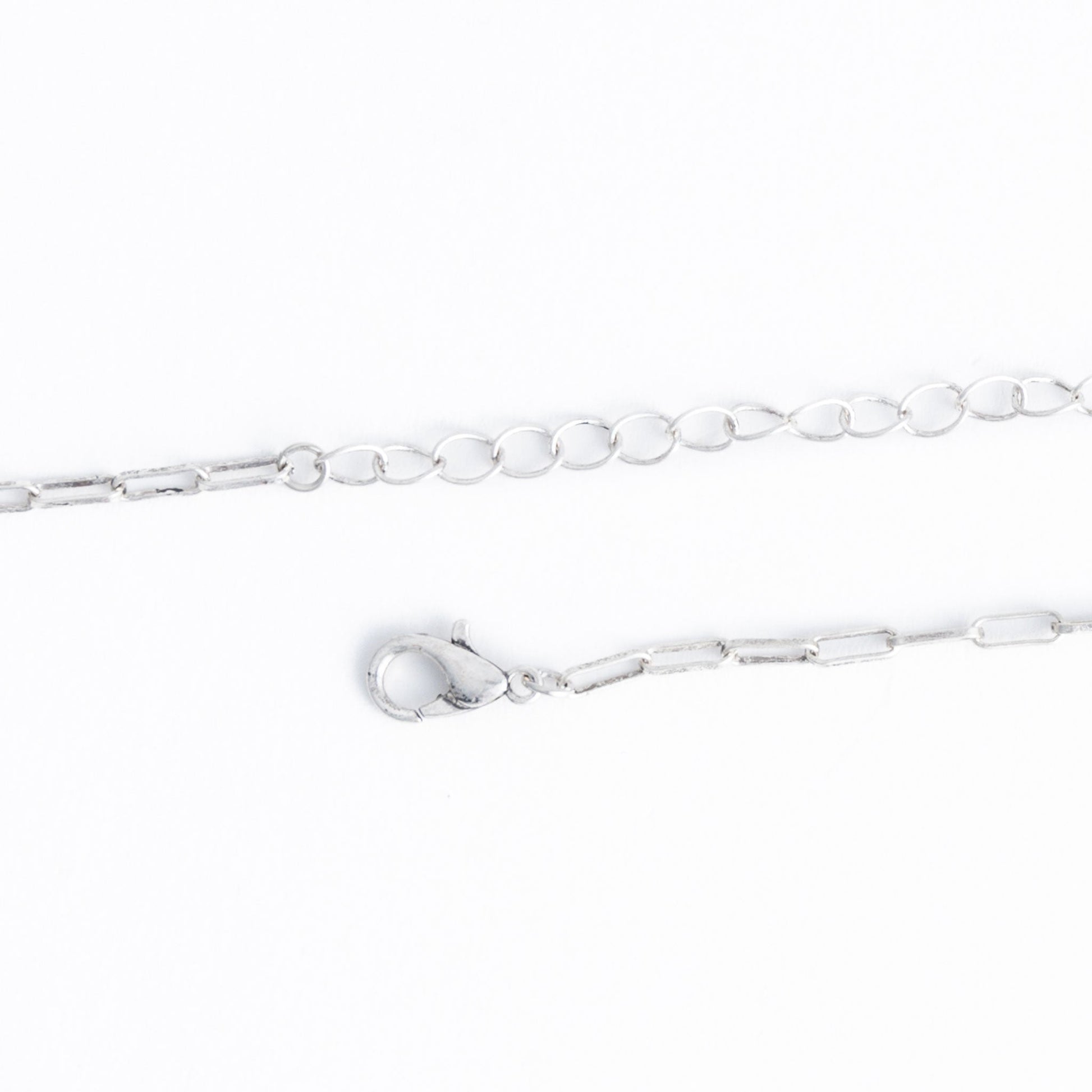 A silver necklace chain closure