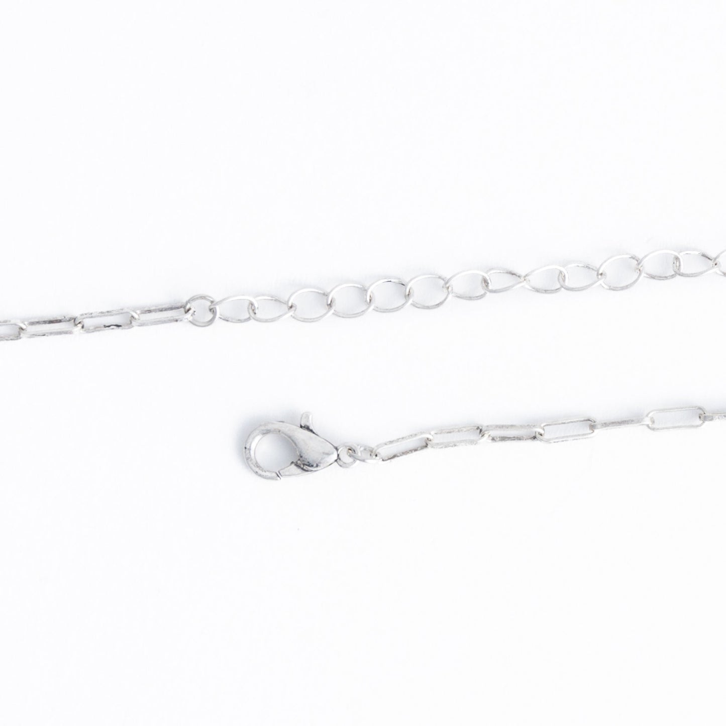 A silver necklace chain closure