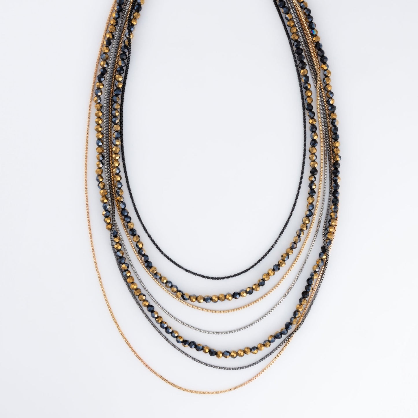 A two-toned, layered necklace with black and gold beads