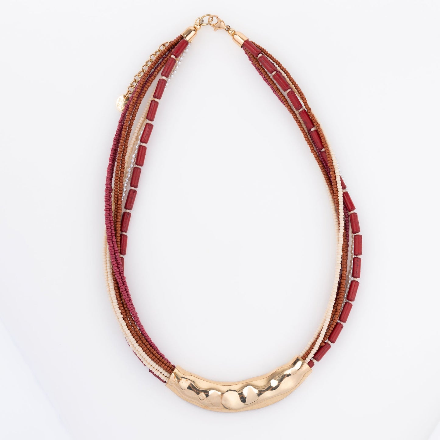 A seed bead necklace in red and gold colors with hammered metal detailing