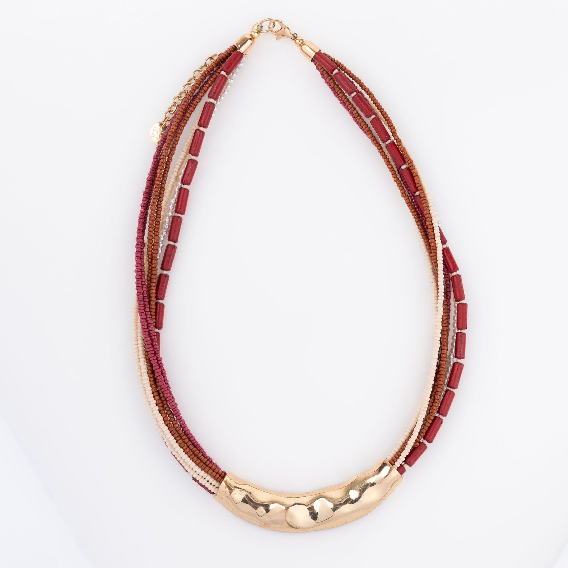 A seed bead necklace in red and gold colors with hammered metal detailing
