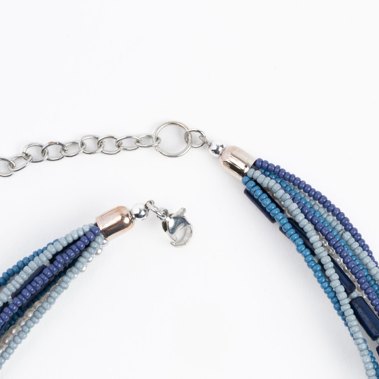 A blue seed bead necklace with a silver lobster clasp closure