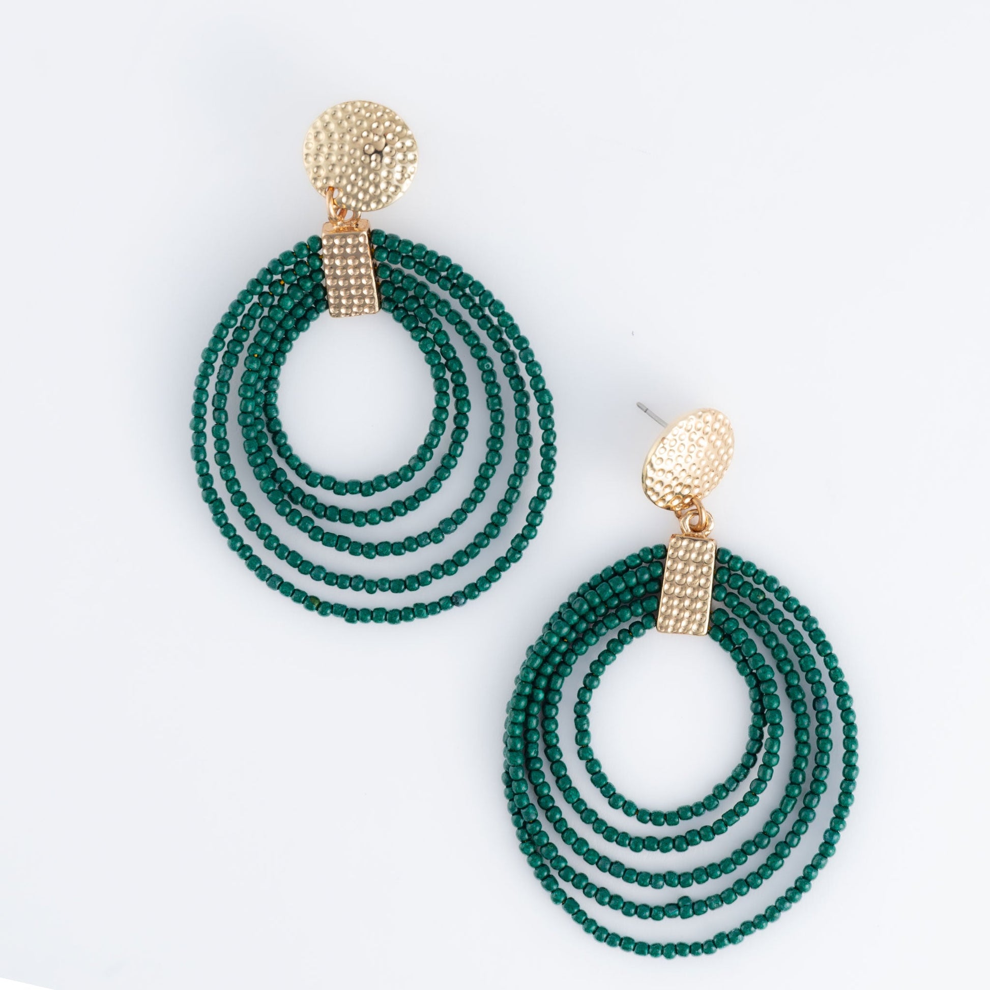 A pair of hoop earrings made of green seed beads with gold detailing at the top.