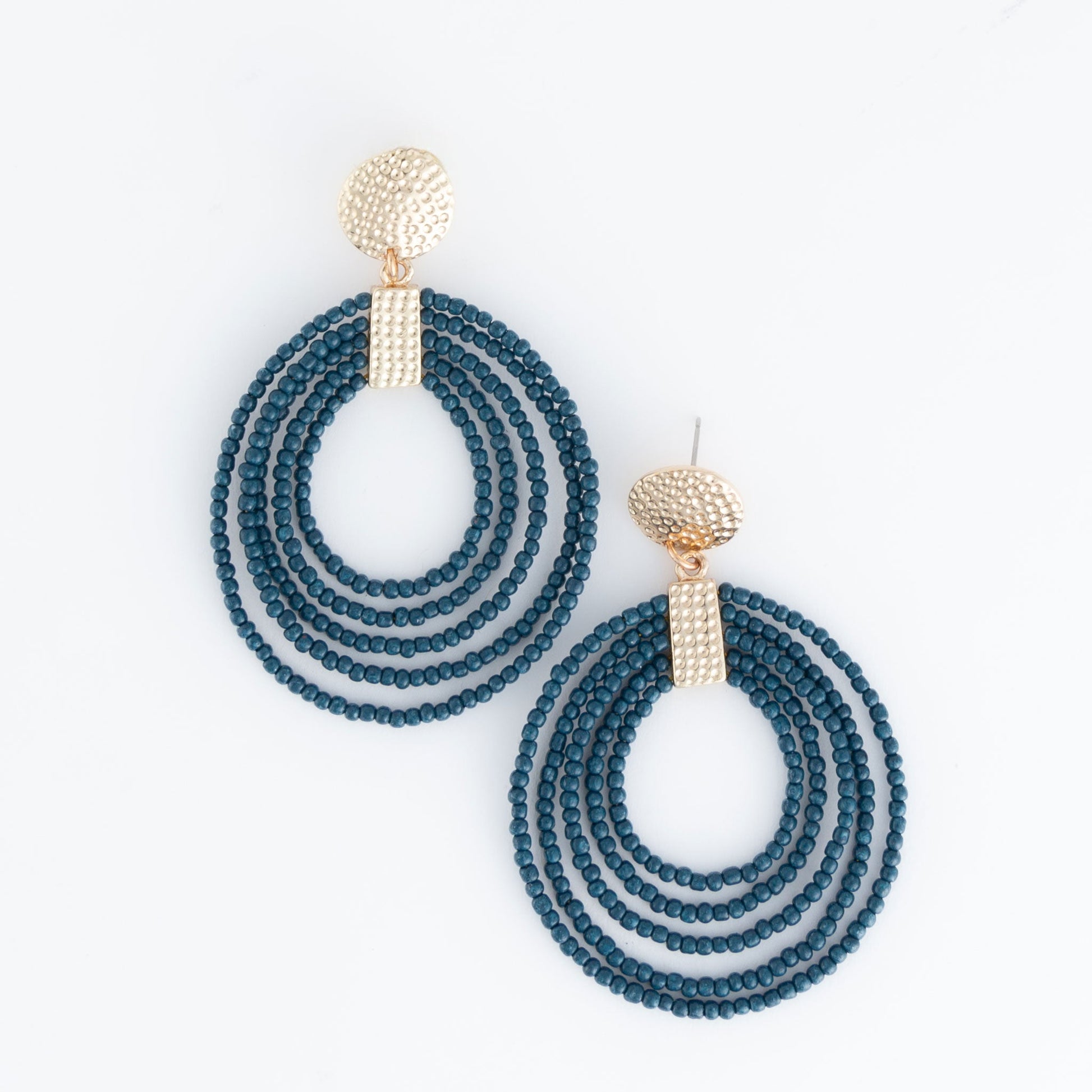 A pair of hoop earrings made of teal seed beads with gold detailing at the top.