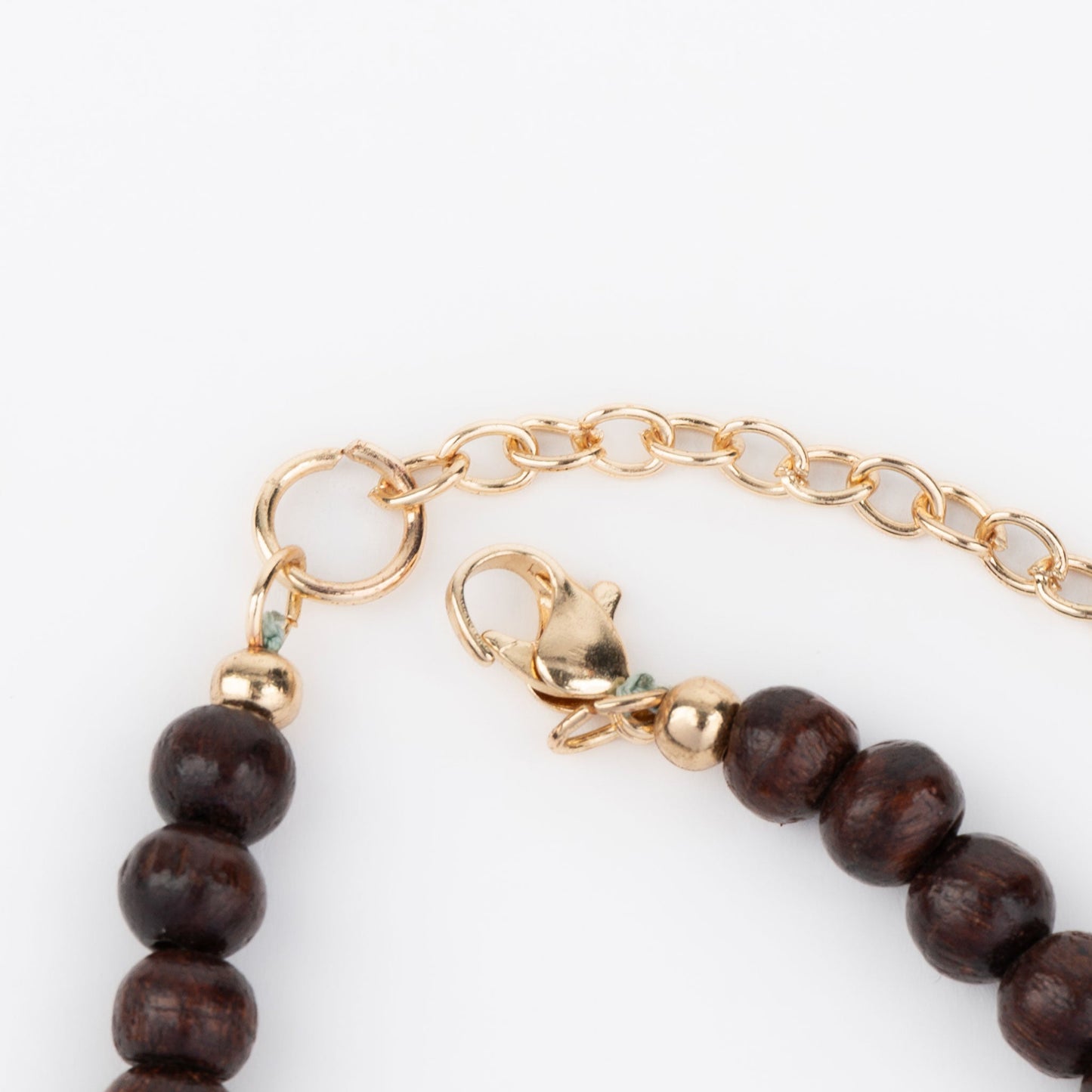 A gold lobster clasp necklace closure