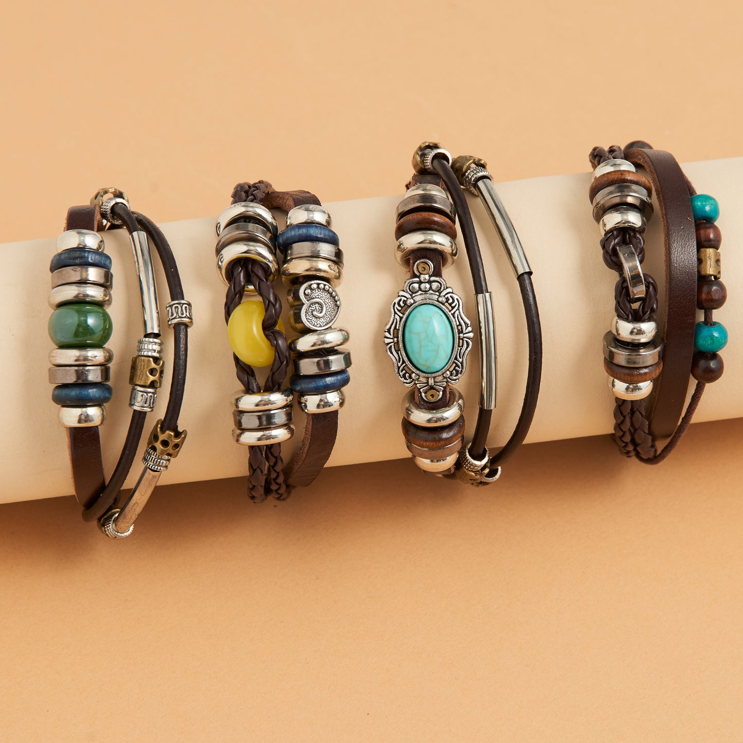 Set of leather and beaded bracelets on a beige surface with a brown background
