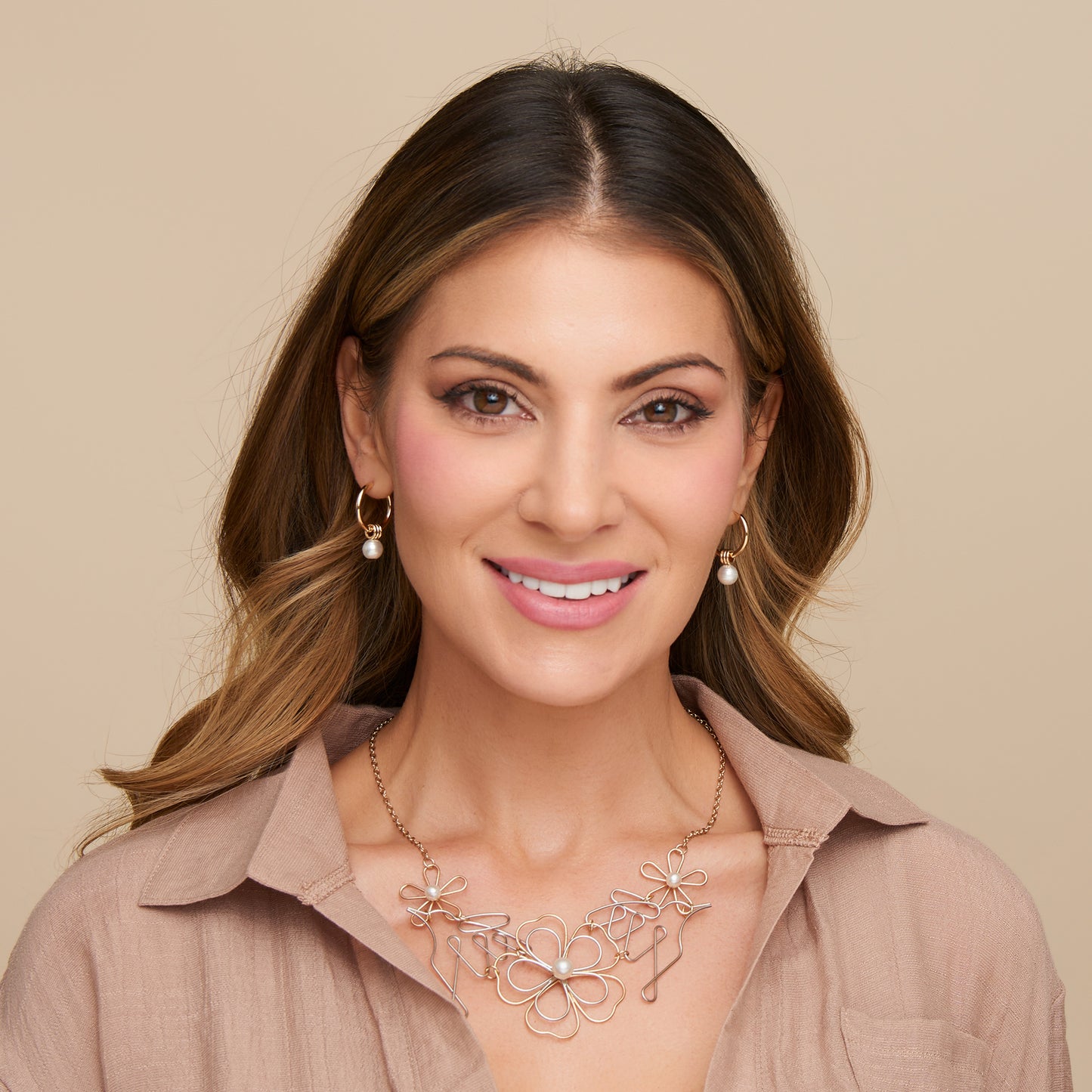 Woman wearing a floral necklace on a beige background