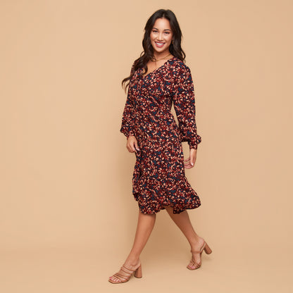 Woman wearing a floral dress on a beige background