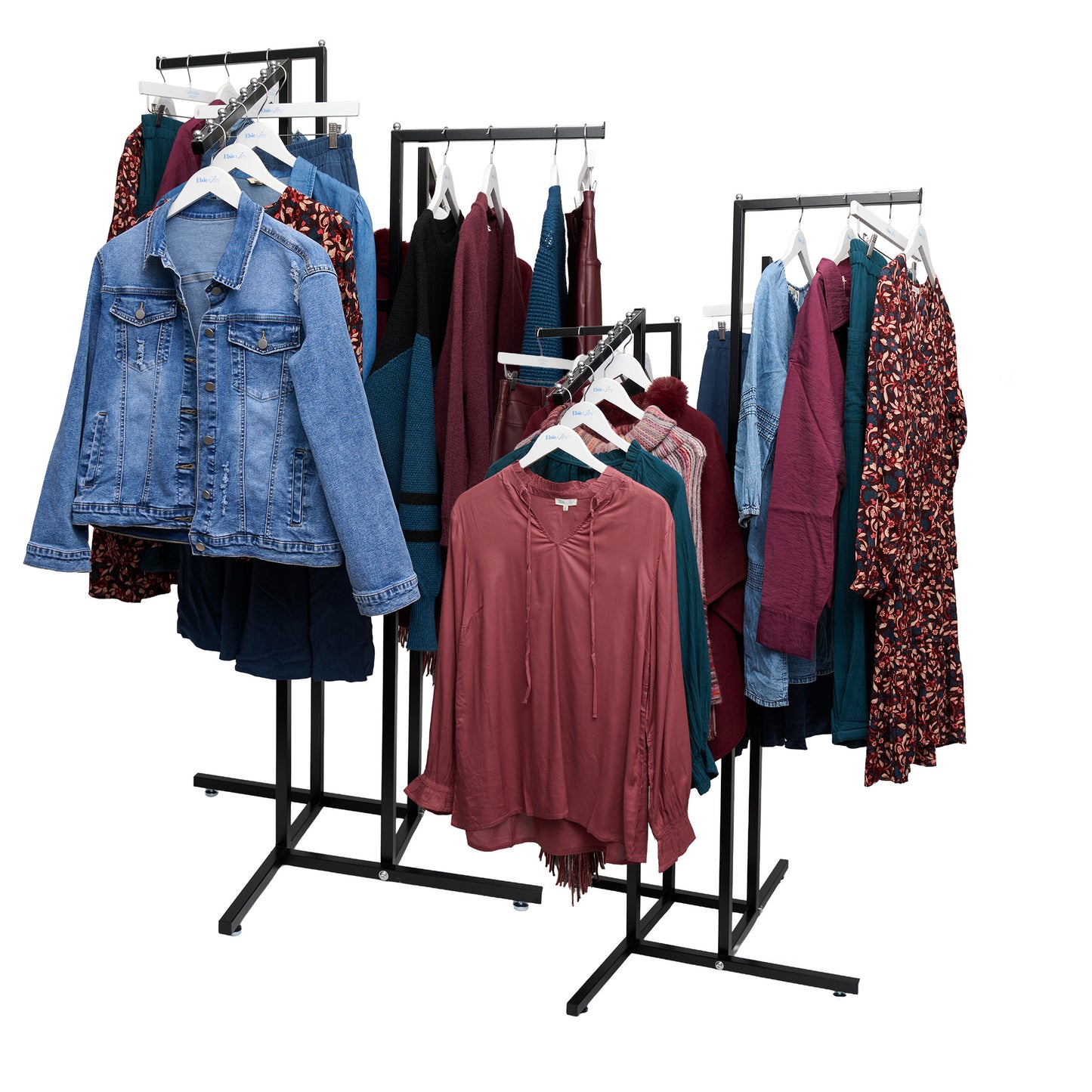 Clothing rack with various garments including a denim jacket and colorful dresses on a white background